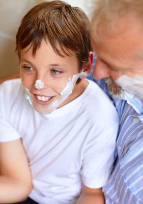 father showing son how to shave for the first time, beginner grooming