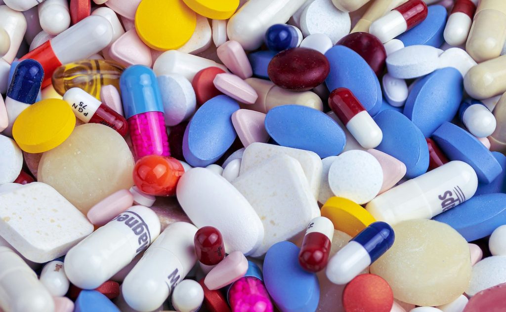 Selection of vitamins tablets and capsules that assist healthy hair growth